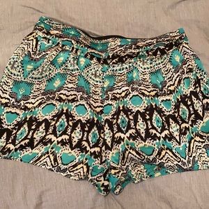 Teal, black, yellow tribal design shorts.